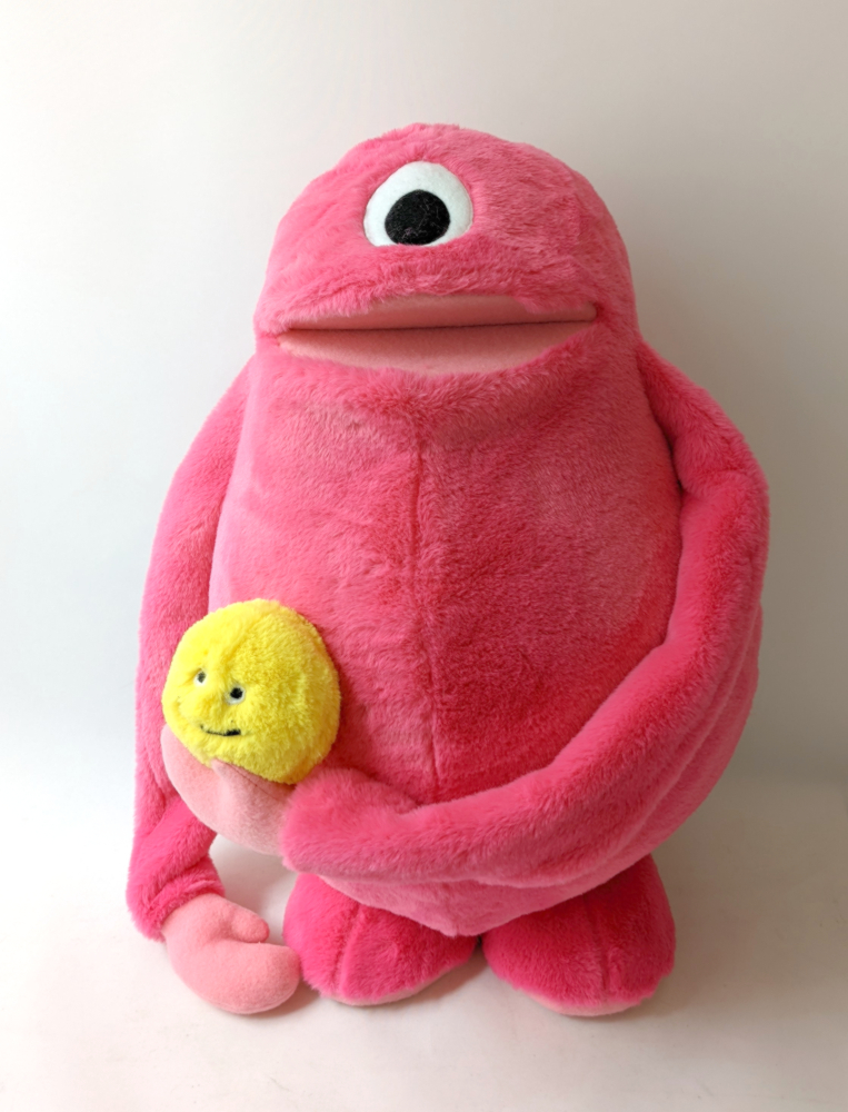 A custom pink furry hand puppet with a moving mouth