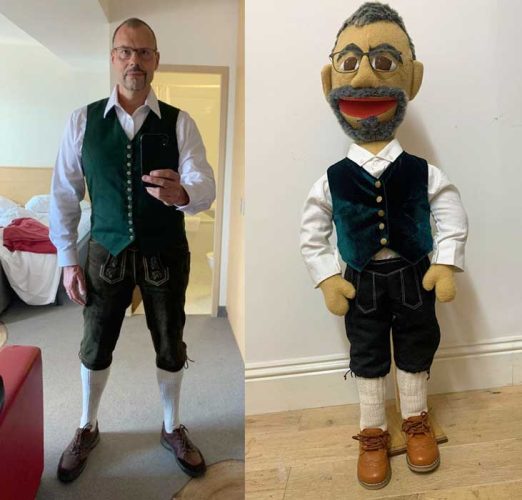 Side by side of a man in Lederhosen, shirt and waistcoat, next to a puppet emulating him
